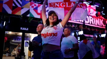 Pendukung Inggris merayakan kemenangan usai peluit akhir dibunyikan  pada pertandingan semifinal EURO 2020 antara Inggris dan Denmark, di Boxpark Croydon di London selatan (8/7/2021). Inggris menang atas Denmark dengan skor 2-1. (AFP/Tolga Akmen)