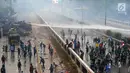 Polisi menyemprotkan air menggunakan water cannon ke arah mahasiswa saat demonstrasi menolak pengesahan RUU KUHP dan revisi UU KPK di depan Gedung DPR, Jakarta, Selasa (24/9/2019). Polisi menyemprotkan air ke arah mahasiswa karena menolak untuk dibubarkan. (merdeka.com/Arie Basuki)