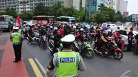 Petugas Polisi berjaga-jaga saat aksi pengendara sepeda motor di Bundaran HI, Jakarta, Minggu (22/12/2014) (Liputan6.com/Johan Tallo)