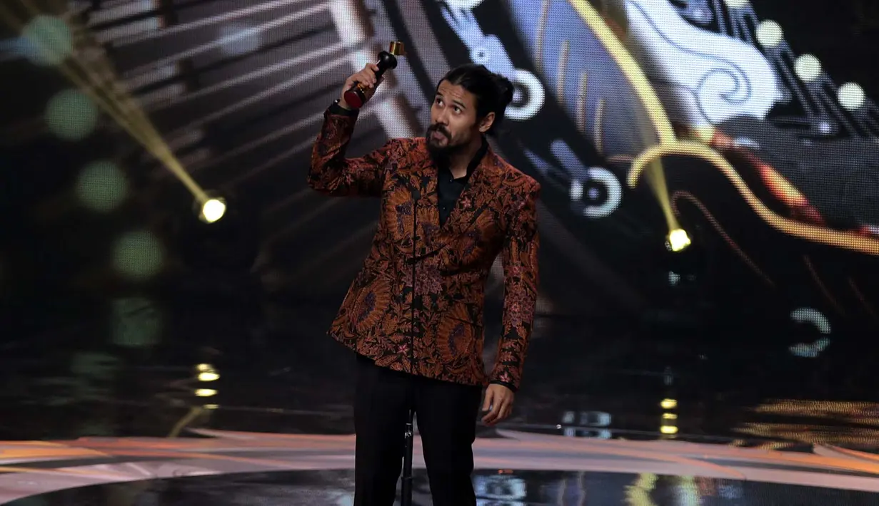 Rona bahagia Chicco Jerikho sangat terpancar saat mengangkat piala kemenangan sebagai Pemeran Utama Pria Terpuji Film Bioskop. Ia membuktikan keberhasilannya di film Filosopi Kopi 2: Ben & Jody. (Deki Prayoga/Bintang.com)