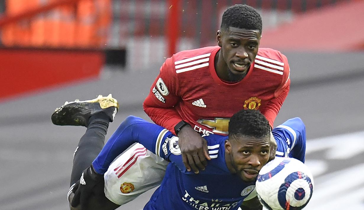 Bek Manchester United, Axel Tuanzebe (atas) berebut bola dengan striker Leicester City, kelechi Iheanacho dalam laga lanjutan Liga Inggris 2020/2021 pekan ke-35 di Old Traffod Stadium, Manchester, Selasa (11/5/2021). Manchester United kalah 1-2 dari Leicester. (AP/Peter Powell/Pool)