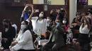 Orang tua, mengenakan masker pelindung, mengambil foto upacara Perjamuan Kudus pertama anak-anak mereka di tengah pandemi virus corona baru di gereja Katolik Nuestra Senora de la Merced di Lima, Peru, Jumat (3/12/2021). (AP Photo/Martin Mejia)