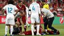 Striker Liverpool, Mohamed Salah, terkapar setelah mendapat bantingan dari Sergio Ramos pada laga final Liga Champions di Stadion NSC Olimpiyskiy, Kiev, Minggu (27/5/2018). Salah mengalami cedera bahu usai dilanggar Ramos. (AP/Pavel Golovkin)