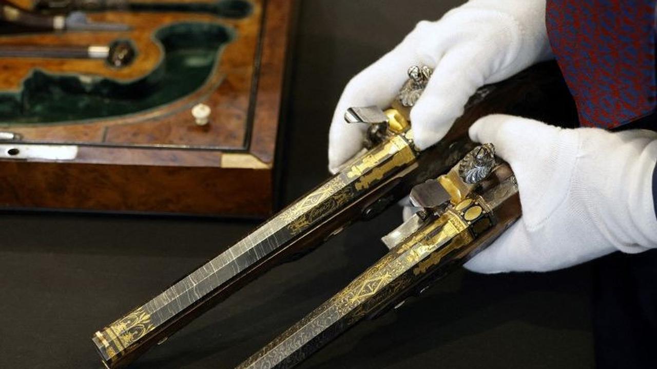 Seorang petugas menunjukkan dua pistol langka milik Kaisar Prancis Napoleon Bonaparte di Paris, Prancis, pada 18 Juni 2024. Sepasang pistol langka, yang dulunya ingin digunakan Napoleon Bonaparte untuk bunuh diri, akan dilelang dan diperkirakan terjual hi