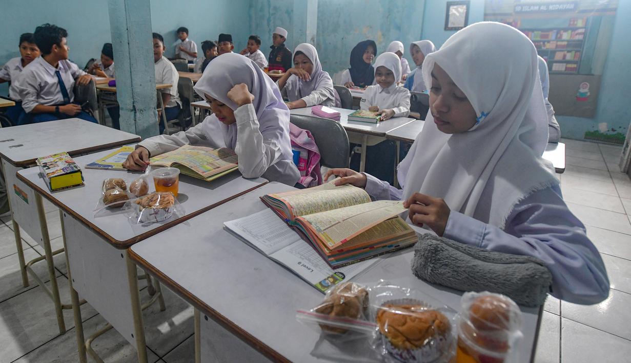 Tote bag ini dibuat dua warna berbeda agar mudah diidentifikasi dalam distribusi MBG antara periode pertama ke periode selanjutnya. Tampak dalam foto, siswa menerima makanan program Makan Bergizi Gratis (MBG) Ramadan di SDI Al Hidayah, Cinere, Depok, Selasa (24/2/2026). (merdeka.com/Arie Basuki)