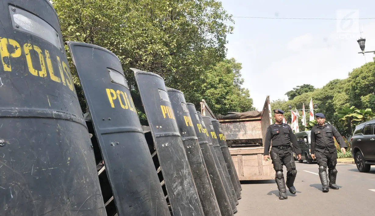 Personel Polri melakukan pengamanan di Gedung KPU,  Jakarta Pusat, Minggu (30/6/2019). Aparat kepolisian memperketat penjagaan KPU dengan menutup Jalan Imam Bonjol menjelang rapat pleno terbuka penetapan pasangan calon presiden dan wakil presiden terpilih Pemilu 2019. (merdeka.com/Iqbal S Nugroho)