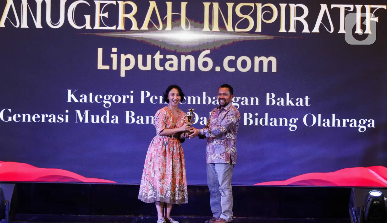 Chief Content Officer (COO) KapanLagi Youniverse, Wens Manggut (kanan) memberikan plakat kepada perwakilan XL Axiata melalui Head Youth Marketing Communications, Nahdiah Estu saat acara Anugerah Inspiratif Liputan6.com di hotel Shangri La, Jakarta, Rabu (31/7/2024). Axis - XL Axiata menerima  penghargaan Kategori Pengembangan Bakat Generasi Muda Bangsa Bidang Olahraga. (Liputan6.com/Herman Zakharia)