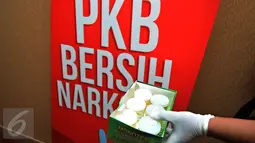 Petugas menujukkan sampel urine anggota Fraksi PKB di Gedung DPR, Senayan, Jakarta, Rabu (16/3). Tes urine yang bekerjasama dengan BNN itu diikuti 36 anggota dewan untuk mengantisipasi penyalahgunaan narkoba. (Liputan6.com/Johan Tallo)