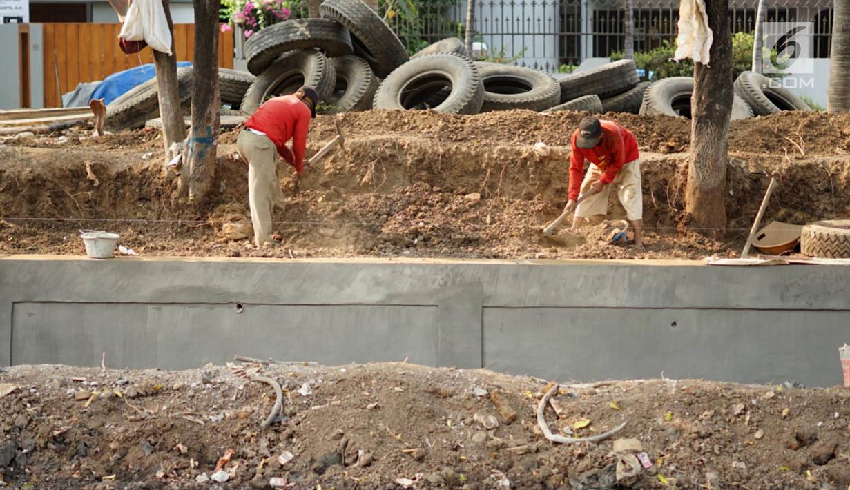 Pekerja menyelesaikan pembuatan turap bermaterialkan ban bekas di Kali Karang Bolong, Ancol, Jakarta, Rabu (4/9/2019). Pembangunan turap yang berpondasi cerucuk dolken dan kaso dengan ketinggian 3,5 meter menggunakan 2.400 ban bekas truk sampah. (Liputan6.com/Immanuel Antonius)