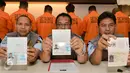 Petugas menunjukan pasport WNA saat rilis di kantor Imigrasi Kelas 1 Jakarta Timur, Rabu (18/1). Sebanyak 11 wna diamankan petugas imigrasi karena tidak memiliki surat resmi. (Liputan6.com/Yoppy Renato)