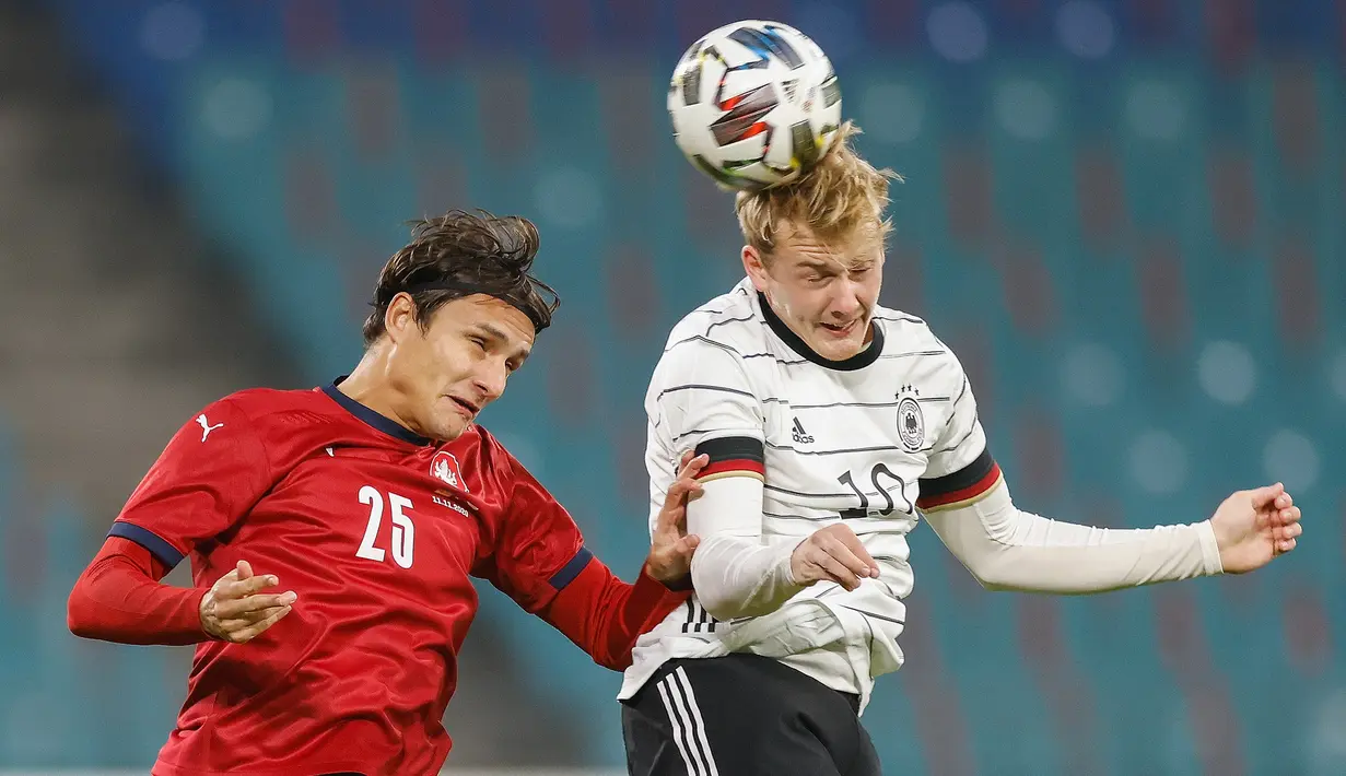 Gelandang Jerman, Julian Brandt, berebut bola dengan bek Republik Ceko, Ales Mateju, pada laga uji coba di RB Arena, Kamis (12/11/2020) dini hari WIB. Jerman menang 1-0 atas Republik Ceko. (AFP/Odd Andersen)