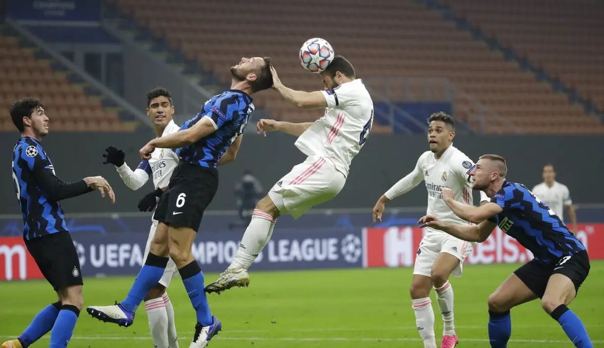 Pemain Inter Milan Stefan de Vrij (kiri) dan pemain Real Madrid Nacho berebut bola pada pertandingan Grup B Liga Champions di Stadion San Siro, Milan, Italia, Rabu (25/11/2020). Real Madrid melumat Inter Milan 2-0. (AP Photo/Luca Bruno)
