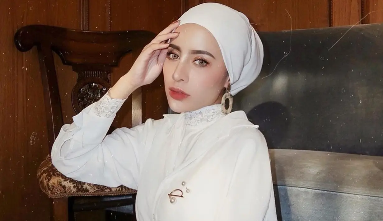 Sebagai warna yang netral, tak salah jika baju putih sering digunakan oleh selebgram asal Malang ini. Dalam momen santai, Aghnia Punjabi tampil memesona dengan baju putih yang dipadukan dengan turban hijab warna senada.(Liputan6.com/IG/@aghniapunjabi)