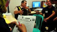Petugas dari Tim Disaster Victim Indentification (DVI) mengisi formulir untuk kelengkapan data antemortem, Bandara Juanda, Surabaya, Rabu (31/12/2014). (Liputan6.com/Johan Tallo)