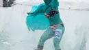 Seorang pemain ski mengenakan kostum patung Liberty meluncur saat ambil bagian dalam kompetisi ski tahunan Gornoluzhnik di resor ski Bobrovy Log, pinggiran kota Siberia, Rusia, 14 April 2019. Kompetisi unik ini digelar untuk menandai akhir musim ski. (REUTERS/Ilya Naymushin)