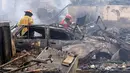 Petugas pemadam memeriksa lokasi kebakaran besar yang melanda permukiman Cantagallo di Lima, Peru, Jumat (4/11). Kebakaran mengakibatkan sekitar 300 rumah rata dengan tanah dan memaksa ribuan warganya mengungsi. (REUTERS/Guadalupe Pardo)