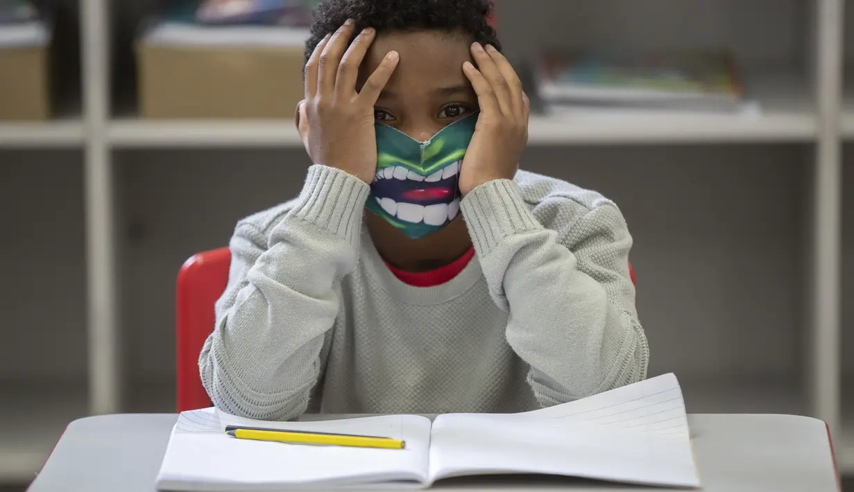 Seorang siswa mengenakan masker pada hari pertama kembali ke kelas tatap muka di tengah pandemi COVID-19 di sekolah umum Raul Antonio Fragoso di Sao Paulo, Brasil (8/2/2021). Pemerintah negara bagian Sao Paulo telah mengizinkan sekolah tatap muka. (AP Photo/Andre Penner)