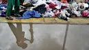 Seorang anak memilih pakaian sumbangan yang ditempatkan di pinggir Kali Ciliwung, Kampung Pulo, Jakarta Timur, Senin (6/1/2020). Banjir menyebabkan ratusan warga di Kampung Pulo kehilangan pakaian akibat rusak dan hanyut. (merdeka.com/Iqbal S. Nugroho)