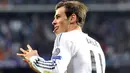 Pertandingan baru berjalan tiga menit Gareth Bale mampu membuka keunggulan madrid. Tampak Bale melakukan selebrasi khasnya (AFP Photo/Javier Soriano).