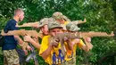 Siswa memegang senapan kayu saat mengikuti pelatihan di kamp paramiliter di Kiev, Ukraina, (8/7). Konflik yang terjadi di bagian timur Ukraina membuat beberapa orang tua sangat ingin memastikan anak-anak mereka siap jika perang. (AP Photo/Efrem Lukatsky)