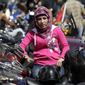 Ilustrasi wanita duduk di sepeda motor. (arabianbusiness.com)