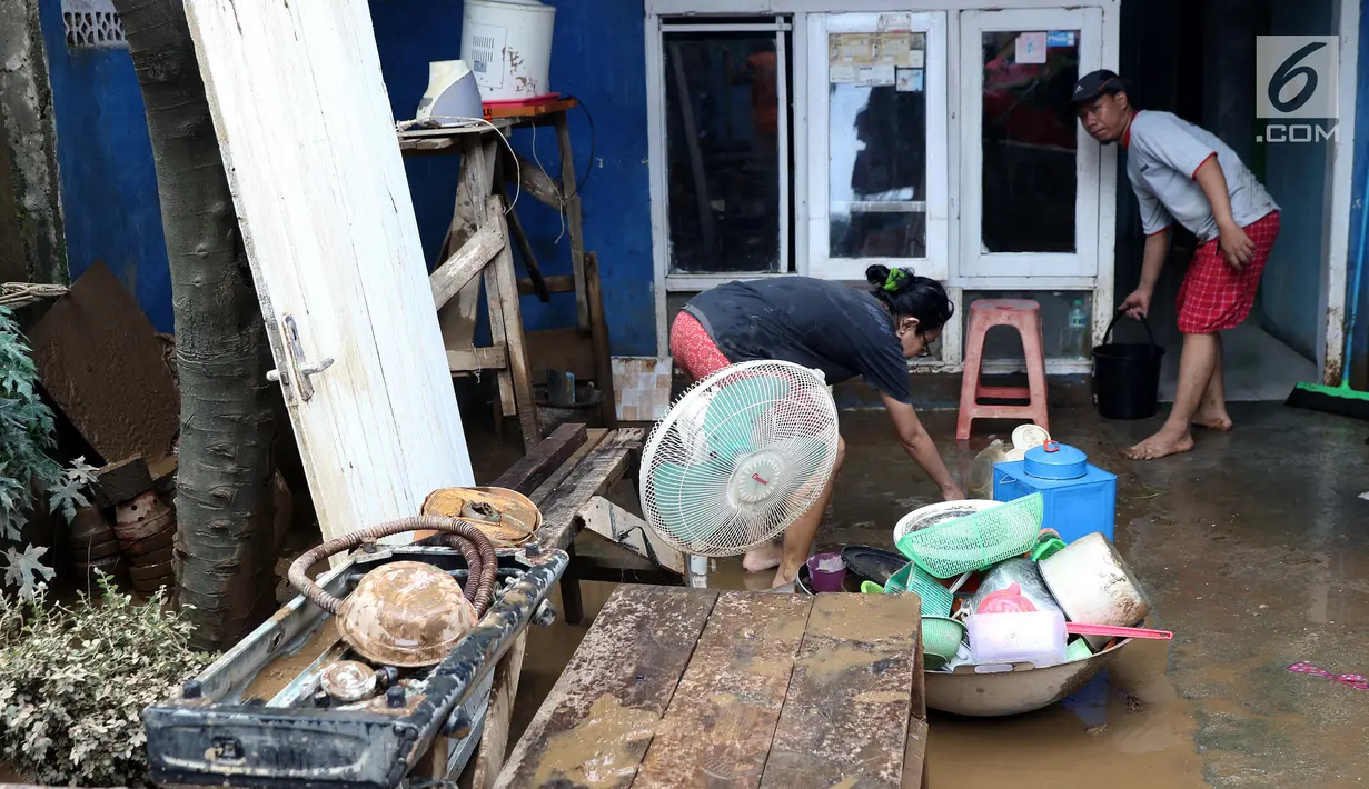 Warga membersihkan lumpur sisa banjir yang melanda kawasan Rawajati, Jakarta, Sabtu (27/4). Banjir akibat luapan air sungai Ciliwung sempat melanda kawasan ini pada Jumat (26/4). (Liputan6.com/Helmi Fithriansyah)