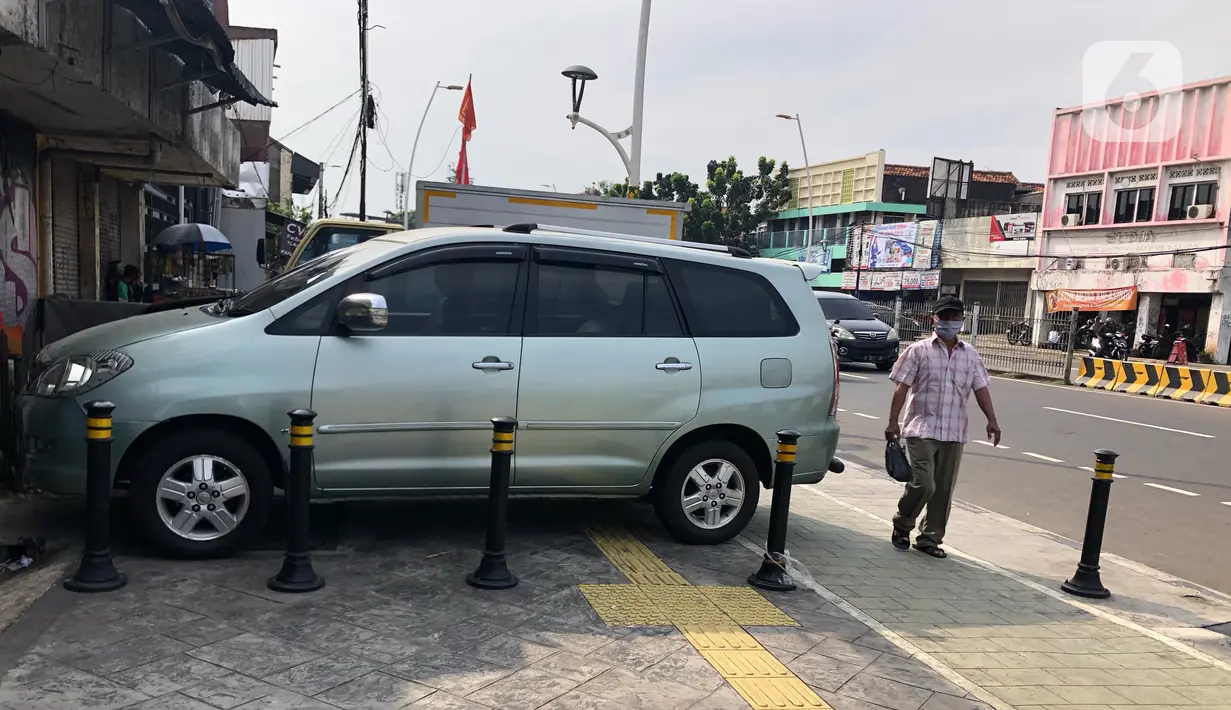Kendaraan terparkir di sekitar trotoar kawasan Jatinegara, Jakarta, Selasa (14/7/2020). Tidak adanya sanksi tegas membuat trotoar yang telah diperlebar tersebut justru dimanfaatkan sebagai lahan parkir liar yang mengganggu ketertiban umum. (Liputan6.com/Immanuel Antonius)