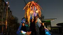 Pemain menunjukkan makhluk misterius setinggi enam meter berhias cahaya saat pratinjau Festival Vivid Sydney di Barangaroo, Sydney, Australia, Rabu (23/5). Vivid adalah acara budaya luar ruangan yang menampilkan instalasi cahaya. (Saeed KHAN/AFP)