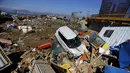 Sebuah mobil bersama puing puing berada di daratan usai gempa bumi melanda Kota Coquimbo, Chile (17/9/2015). Gempa yang menewaskan sekitar sepuluh orang dan memaksa satu juta orang mengungsi dari rumah mereka ke dekat pantai. (REUTERS/Ivan Alvarado)