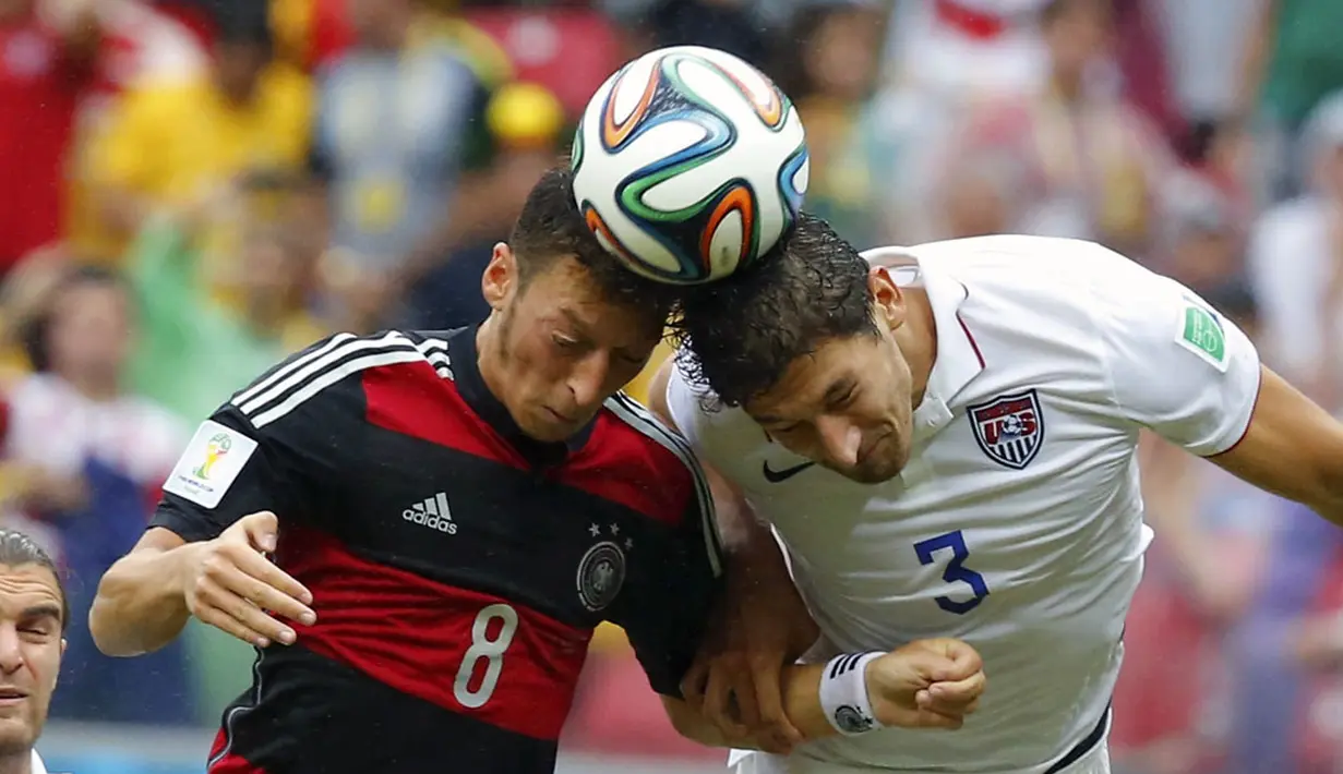 Mesut Ozil (Jerman - kiri) berebut bola dengan pemain belakang AS, Omar Gonzalez saat berlaga di penyisihan Piala Dunia 2014 Grup G di Stadion Pernambuco, Recife, Brasil, (26/6/2014). (REUTERS/Laszlo Balogh)  