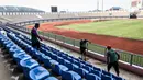 Sejumlah pekerja sedang membersihkan bangku penonton di Stadion Indomilk Arena, Tangerang pada Rabu (25/08/2021) sore WIB. Hal tersebut merupakan salah satu bentuk perawatan dan persiapan stadion untuk menyambut kompetisi BRI Liga 1 yang akan segera bergulir. (Foto: Bola.com/Bagaskara Lazuardi)