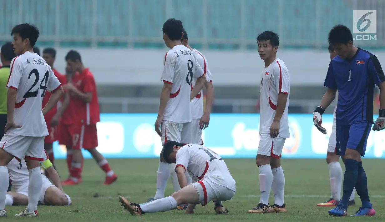 Pemain Korea Utara berkumpul saat laga melawan Bahrain dihentikan sementara akibat lampu mati pada  PSSI Anniversary Cup 2018 di Stadion Pakansari, Kab Bogor, Kamis (3/5). Laga dimenangkan Bahrain 4-1. (Liputan6.com/Helmi Fithriansyah)
