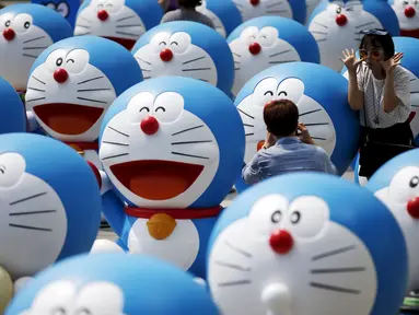 Sejumlah wisatawan saat berselfie di barisan patung Doraemon di Seoul, Korea Selatan,Senin (31/8/2015). Pameran ini menghadirkan seratus patung Doraemon  dengan berbagai pose yang berbeda. (REUTERS/Kim Hong – Ji)