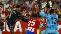 Kiper Girona, Paulo Gazzaniga (kanan) melakukan penyelamatan atas tendangan gelandang Real Madrid, Jude Bellingham (kiri) pada laga pekan ke-8 Liga Spanyol 2023/2024 di Montilivi Stadium, Girona, Spanyol, Sabtu (30/9/2023) malam WIB. (AP Photo/Joan Monfort)