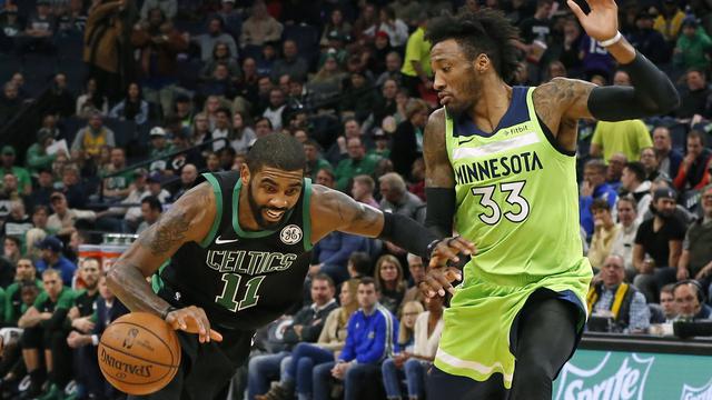 Point guard Celtics Kyrie Irving menerobos pertahanan Timberwolves di laga NBA