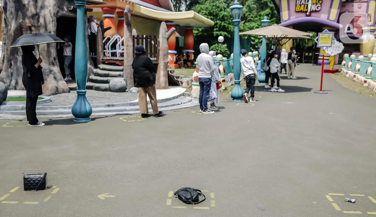 <p>Para pengunjung berdiri pada kotak jaga jarak saat antre untuk menaiki wahana bermain di Dunia Fantasi, Ancol, Jakarta, Minggu (10/10/2021). Pelonggaran PPKM level 3 di Jakarta membuat sejumlah tempat wisata kembali ramai didatangi pengunjung. (Liputan6.com/Faizal Fanani)</p>