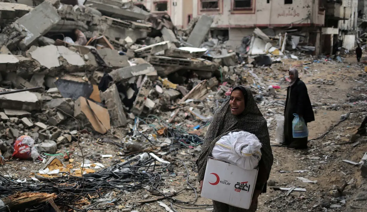 Para wanita Palestina saat meninggalkan Khan Yunis di Jalur Gaza Selatan pada 7 Maret 2024. Pada peringatan Hari Perempuan Internasional 2024, Kementerian Kesehatan Gaza mengumumkan kematian 9.000 perempuan Palestina di Jalur Gaza sejak 7 Oktober 2023. (Foto oleh AFP)