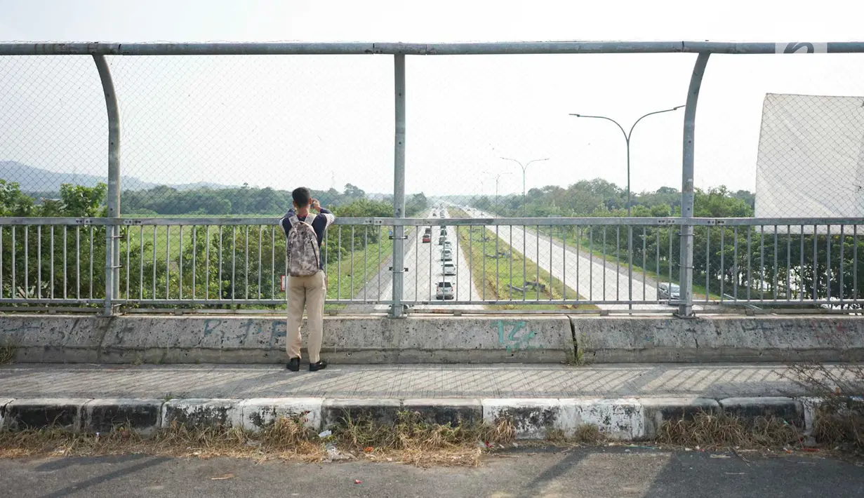 Petugas mengukur kecepatan rata-rata kendaraan dengan alat speed gun di sekitar Gerbang Tol Palimanan, Cirebon, Jawa Barat, Jumat (7/6/2019). Hal itu dilakukan setiap satu jam sekali untuk mengetahui tingkat kepadatan lalu lintas di sepanjang jalur tol Trans Jawa. (Liputan6.com/Immanuel Antonius)