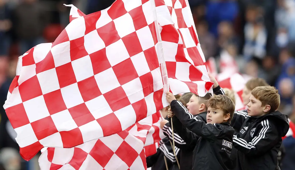 Suporter cilik Stoke City mengibarkan bendera klub sebelum pertandingan antara Stoke City vs Manchester City di Stadion Britania, Sabtu (5/12/2015). (Reuters/Carl Recine)