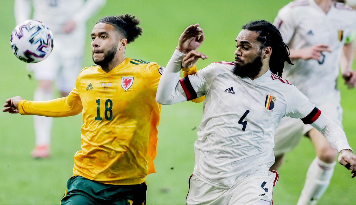 Pemain Belgia, Jason Denaye, berebut bola dengan pemain Wales, Tyler Roberts, pada laga Kualifikasi Piala Dunia 2022 di Stadion Den Dreef, Kamis (25/3/2021). Belgia menang dengan skor 3-1. (AP/Francisco Seco)