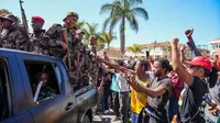 Tentara disambut oleh warga yang berkumpul dalam sebuah upacara untuk mengenang para demonstran yang tewas dalam aksi protes anti-pemerintah baru-baru ini di Antananarivo, Madagaskar, pada Minggu, (12/10/2025). (Dok. AP/Mamyrael)