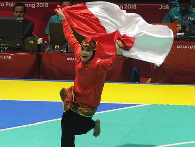 Pesilat Indonesia, Puspa Arumsari, melakukan selebrasi usai menjadi juara Asian Games di Arena Silat TMII, Jakarta, Senin (27/8/2018). Puspa meraih medali emas kelas seni kategori tunggal putri dengan nilai 467. (Merdeka.com/Arie Basuki)