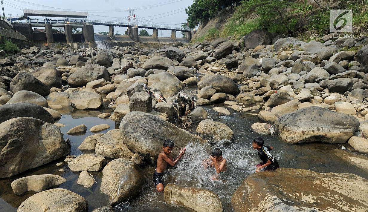 Anak-anak bermain pada kubangan air yang tersisa di kawasan Bendungan Katulampa, Bogor (15/7). Musim kemarau menyebabkan Bendungan Katulampa berada di titik nol berdampak pada sumur-sumur warga di sekitar mengalami kekeringan. (Merdeka.com/Arie Basuki)
