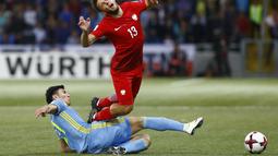 Pemain Kazakhstan, Abzal Beysebekov (kiri) menghalau bola dari kejaran pemain Polandia, Maciej Rybus pada laga kualifikasi piala dunia 2018 di Astana Arena Stadium, Astana, (5/9/2016) dini hari WIB. (REUTERS/Shamil Zhumatov)