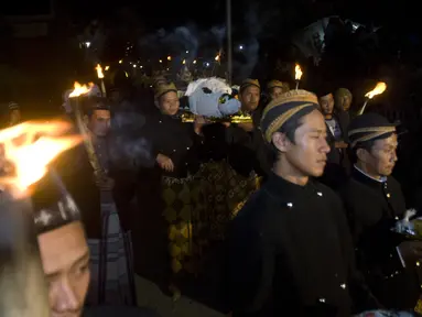 Warga membawa sesaji kepala kerbau dan sejumlah tumpeng pada ritual tahunan 1 Muharam "Sedekah Merapi" di lereng utara Gunung Merapi, Selo, Boyolali, Jateng, Jumat (24/10/2014). (Antara Foto/Andika Betha)