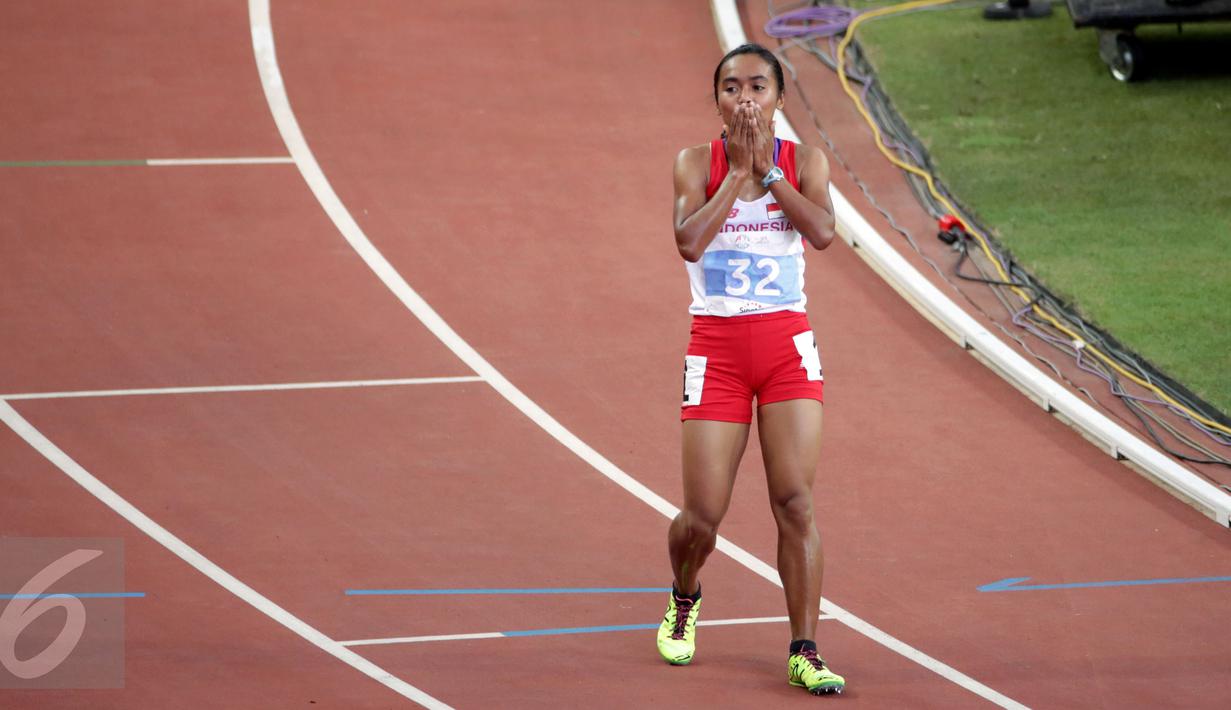 Atlet putri Indonesia, Triyaningsih menutup wajahnya usai finis pertama di nomor 10.000 M di National Stadium Singapura, Kamis (11/6/2015). Triyaningsih mencatatkan waktu 33 menit 44,53 detik dan berhasil meraih emas. (Liputan6.com/Helmi Fithriansyah)