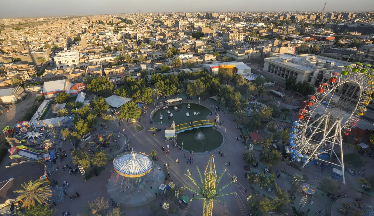 Suasana taman hiburan yang terlihat ramai dipenuhi pengunjung selama liburan Idul Adha di Baghdad. (AP Photo/Hadi Mizban)