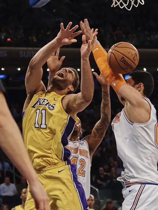 Ekspresi pemain Los Angeles Lakers, Brook Lopez (tengah) saat berebut bola dengan pemain New York Knicks, Enes Kanter pada lanjutan NBA basketball game di Madison Square Garden, New York, (12/12/2017). Knicks menang 113-109. (AP/Andres Kudacki)