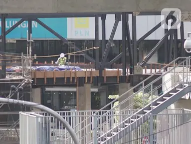 Pekerja menyelesaikan pembangunan proyek jembatan layang atau skybridge Stasiun MRT Asean-Halte Transjakarta CSW di kawasan Kebayoran Baru, Jakarta, Selasa (21/1/2020). (Liputan6.com/Immanuel Antonius)