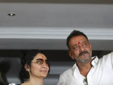 Aktor Bollywood Sanjay Dutt (kanan) mengacungkan jempol untuk para penggemarnya di kediamannya di Mumbai, India, Kamis (25/2). Sanjay telah selesai menjalani hukuman terkait keterlibatannya dalam kasus bom Mumbai pada tahun 1993 (REUTERS/Shailesh Andrade)
